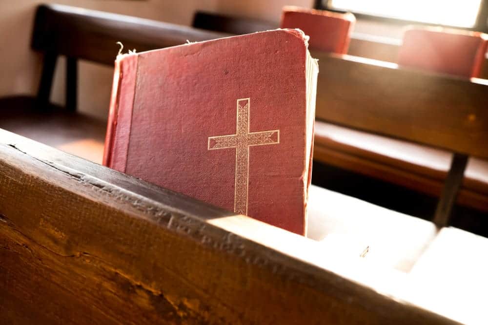 image of red hymnals in the pew to symbolize planning music for liturgy