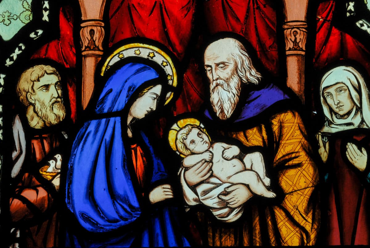 Stained glass depiction of Mary and baby Jesus to accompany text focused on choosing music for solemnities of Mary