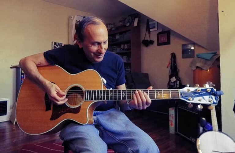Photo of Bobby Fisher teaching chord construction on guitar