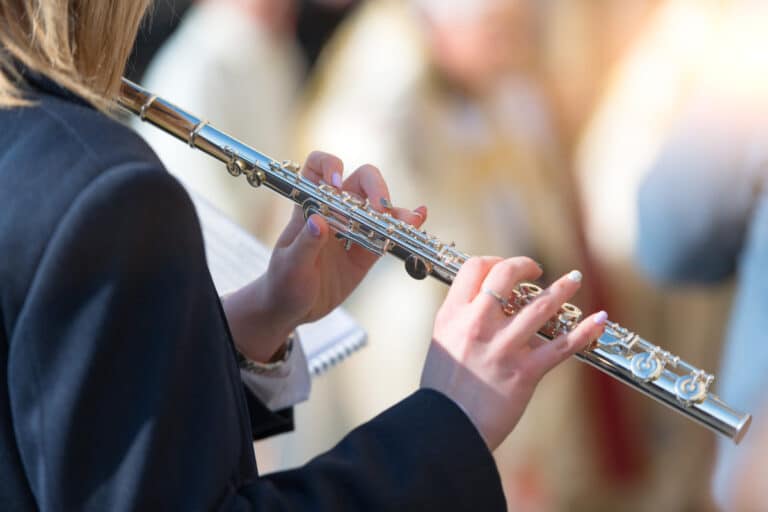 photo of a woman playing a flute as a visual representation of recruiting volunteers for music ministry