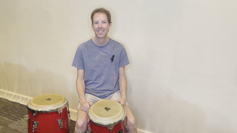 Photo of Brian Malone teaching about playing congas in 4/4 time.