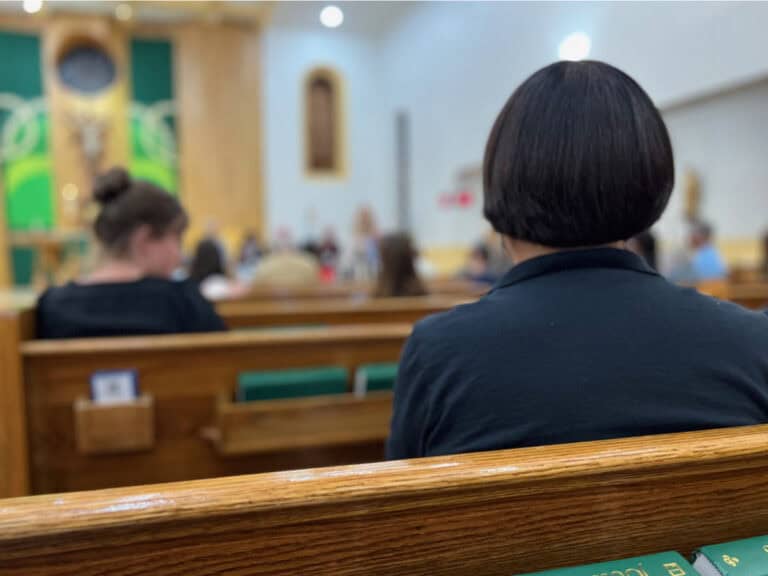 Photo of people at church listening to Liturgy of the Word music