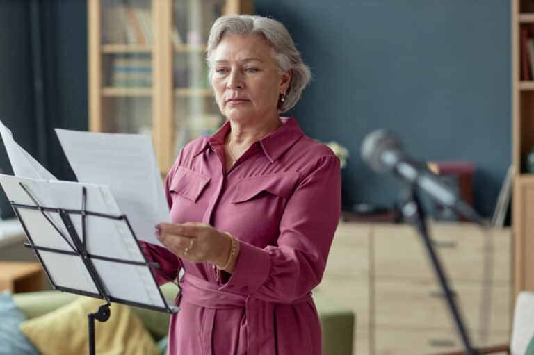 An older woman at a music stand to illustrate caring for the aging voice