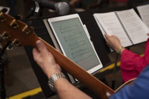 Image of a guitarist and a singer with music to illustrate copyright compliance in music ministry
