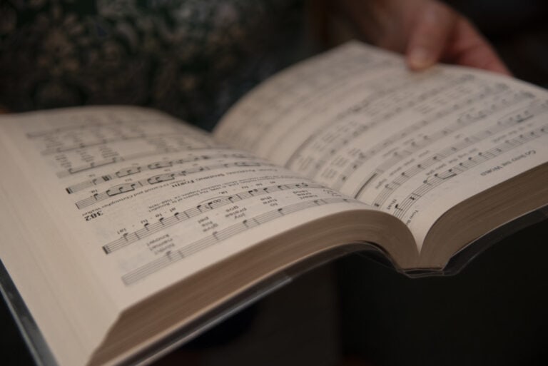Photo of a choir member holding a hymnal to go along with the idea of embracing change in leadership transitions