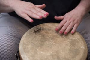 Photo of a woman playing a hand drum to illustrate tips for ensemble musicians