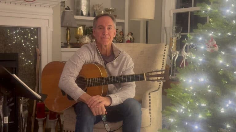 Photo of Steve Petrunak demonstrating a right hand strumming technique on guitar