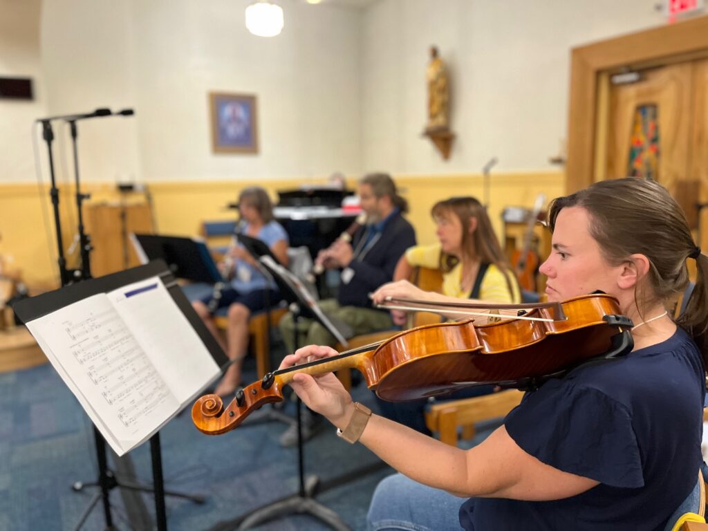 Ensemble musicians singing together during CLEF mal training rehearsal