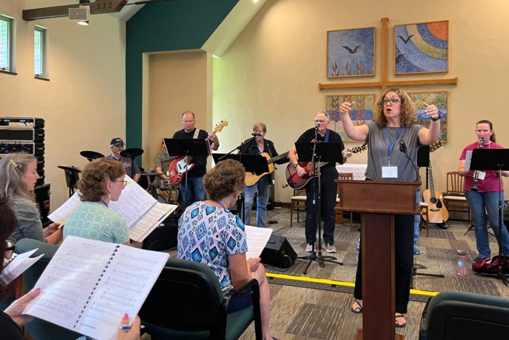 Ensemble musicians rehearsing liturgical music using Catholic music resources and ministry resources to support parish worship