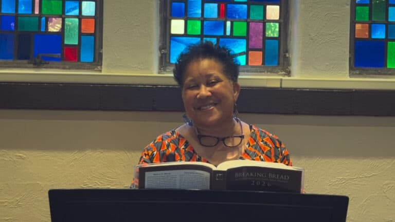 Photo of Lynne Gray talking about her song, Great God of Love